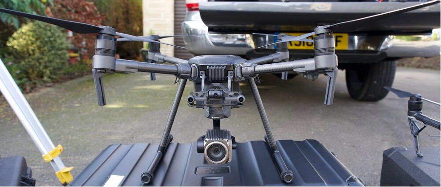 A black top inspection drone sat on a case.