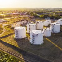 An aerial drone shot of tanks with petroleum products are among the fields near the village.