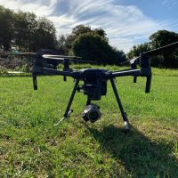 A drone placed in a field, ready to go airborne, and take aerial imagery.