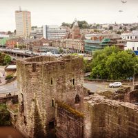 A drone shot of a castle wall, with the city in the landscape, during an aerial inspection by RUAS.