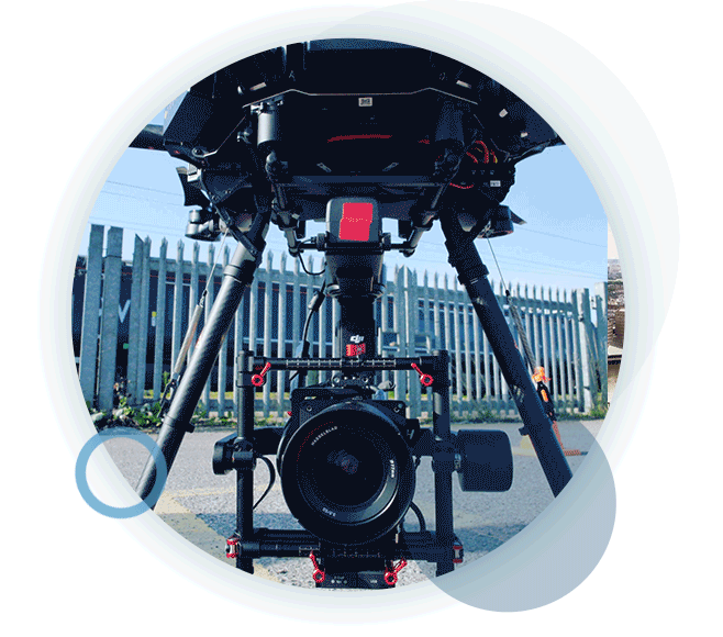 A circular gif containing a close-up shot of a drone being prepared to perform an aerial survey.