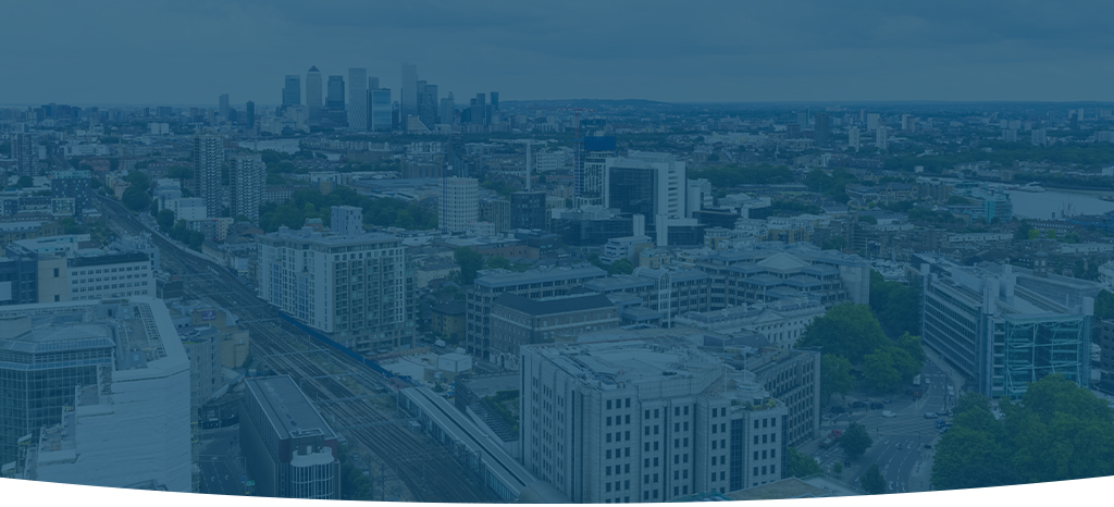 A dimmed aerial drone shot of a city taken during a building survey.