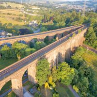 An aerial view of a double railway bridge in the Peak District used during infrastructure assessment.