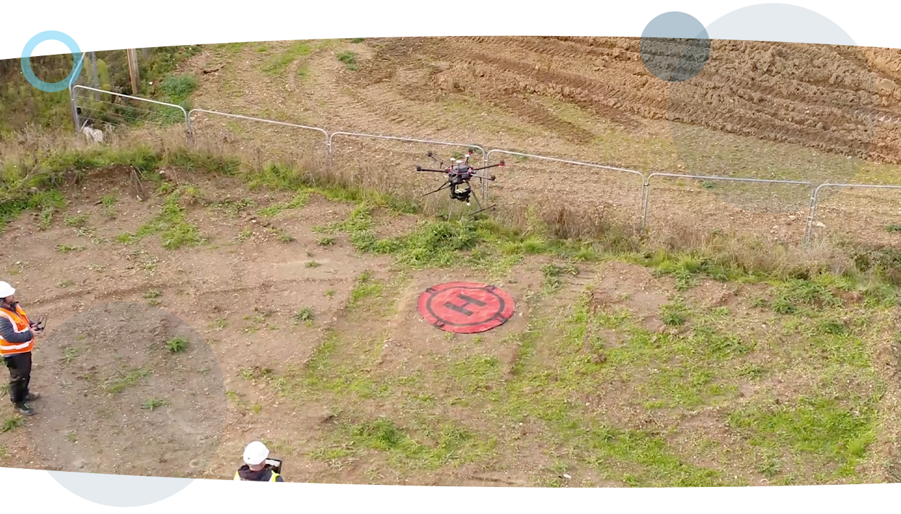 An aerial shot of a drone going airborne in a field, captured by a RUAS trained drone pilot performing an oil inspection.