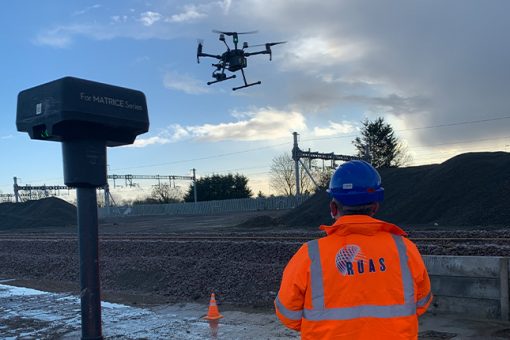 A RUAS trained drone pilot, in a power plant using a radio controlled transmitter to fly the drone. The drone will produce an orthomasics model of the power plant.