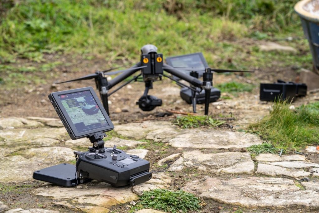 A drone being prepared for take off surrounded by drone radio transmitters.