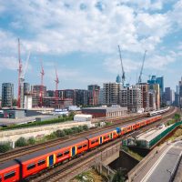 A landscape view of trains going to Waterloo station at New Covent Garden Market.