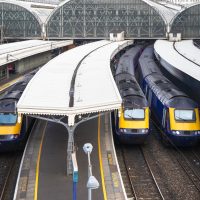 An aerial drone shot of trains leaving at Paddington railway station in London.