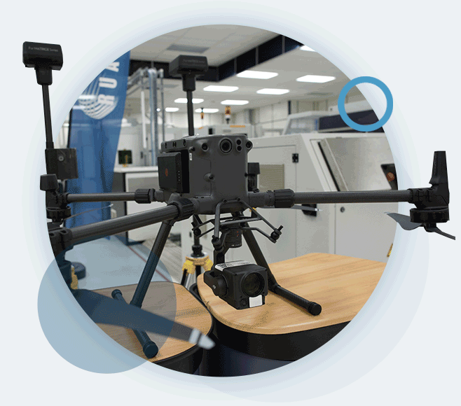 A circular gif of a drone on a table in the RUAS facilities, in preparation for a survey.
