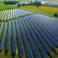 An aerial drone shot of a solar panel power plant farm in France.