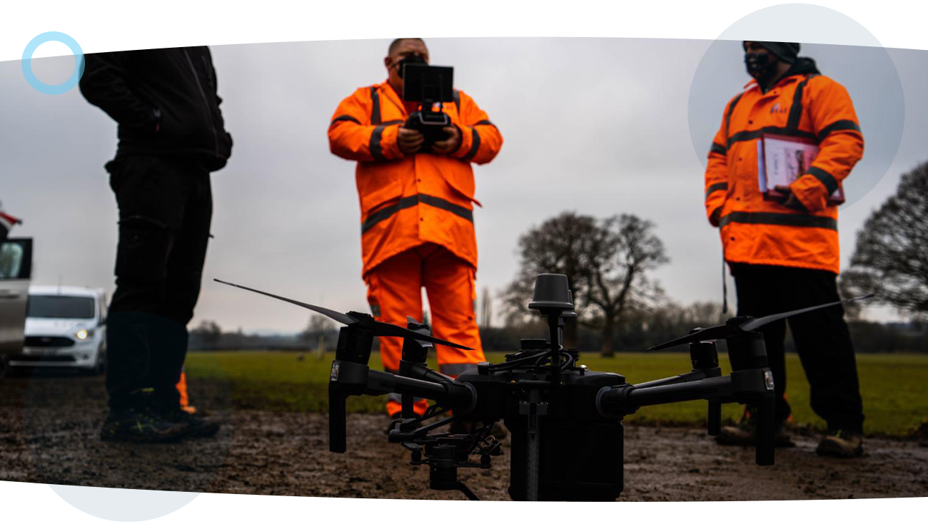Three men stood around a drone preparing to go airborne and take some spectral imagery.