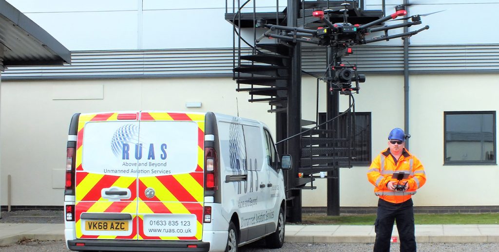 A RUAS trained drone pilot using a drone radio transmitter during a thermal inspection.