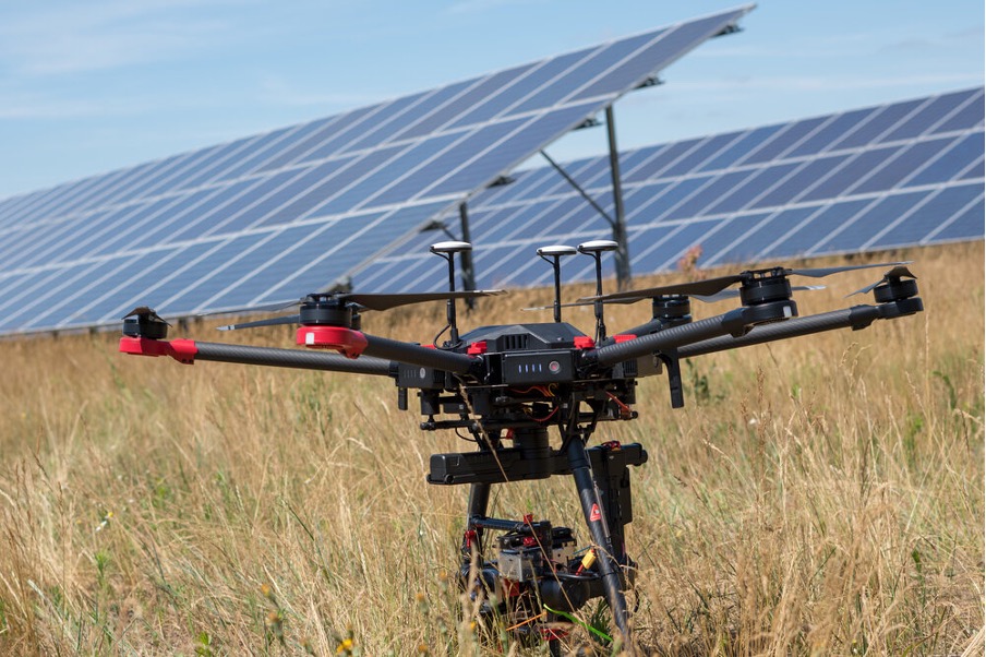 A close up shot of a drone preparing for the inspection of a solar panel farm.