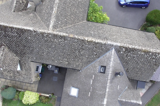 A drone shot of a house roof during a roof inspection.