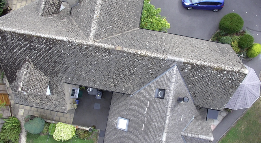 A drone shot of a house roof during a roof inspection.