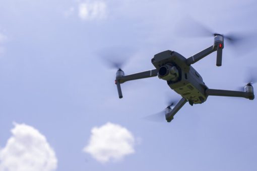 A drone flying in the sky with the proper UK rules and regulations.