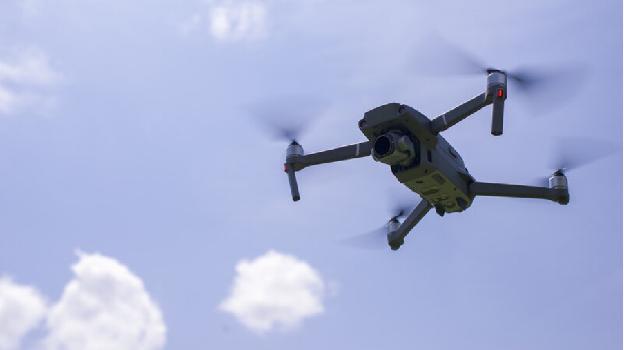 A drone flying in the sky with the proper UK rules and regulations.