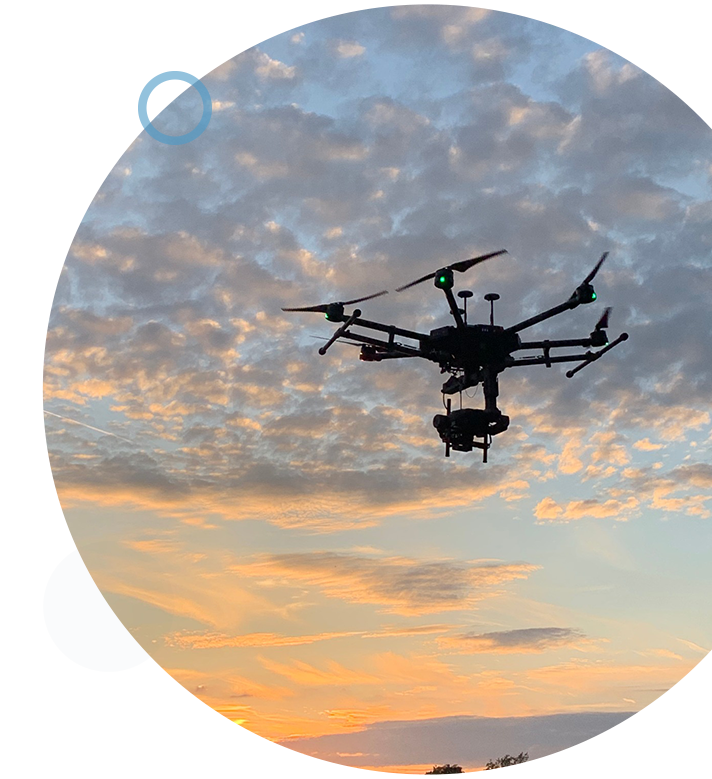 Circular image of an airborne drone during a sunset, performing an aerial inspection.