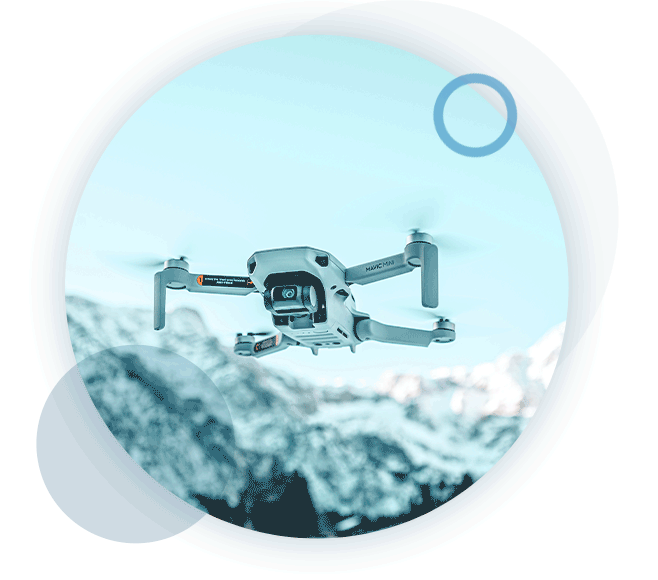 A circular gif of an airborne drone being flown by a RUAS trained drone pilot.