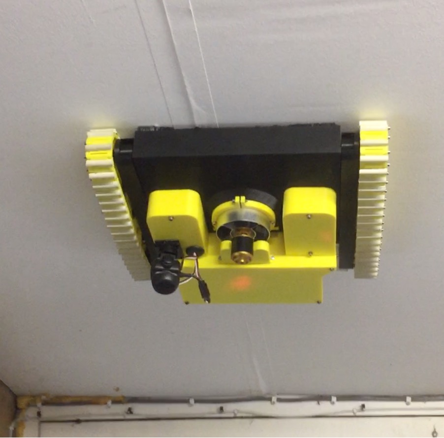 A Surface Adherence ROV “Wallcrawler” on the ceiling.