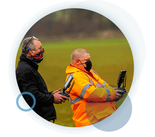 A circular gif of two RUAS trained drone pilots, using drone radio transmitters.