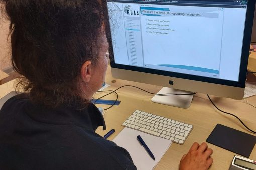 A lady taking a mock exam during drone training on a Mac.